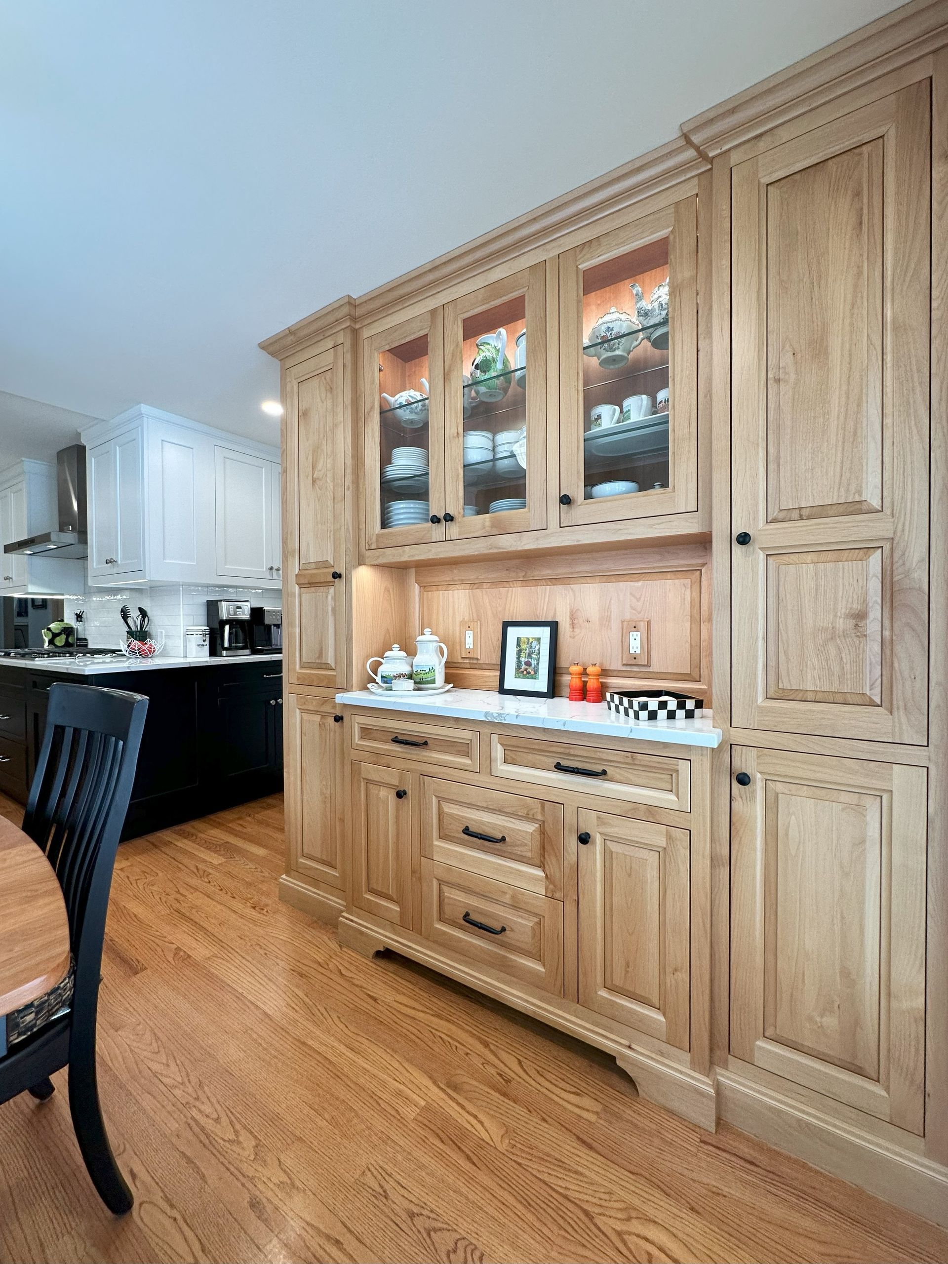 A kitchen with wooden cabinets and a table and chairs