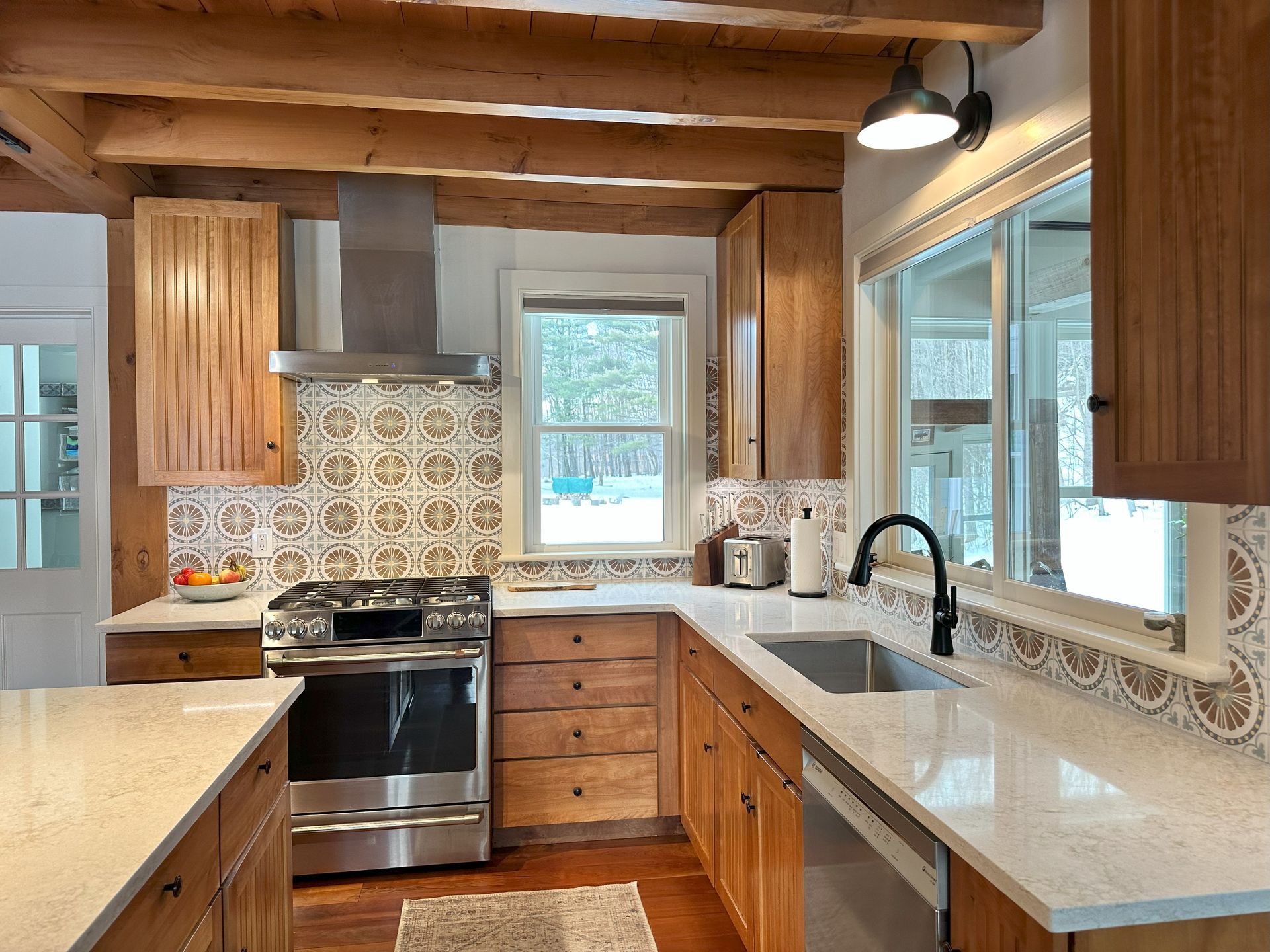 A kitchen with stainless steel appliances and wooden cabinets