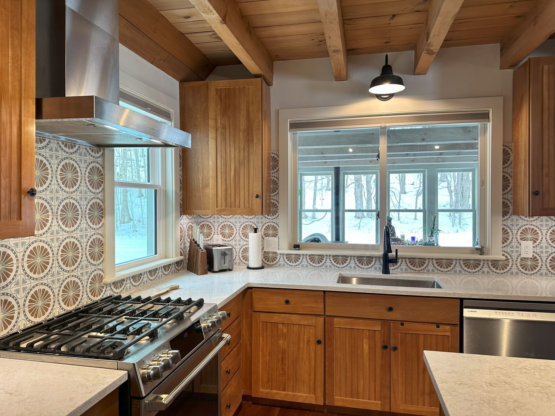 A kitchen with wooden cabinets and stainless steel appliances