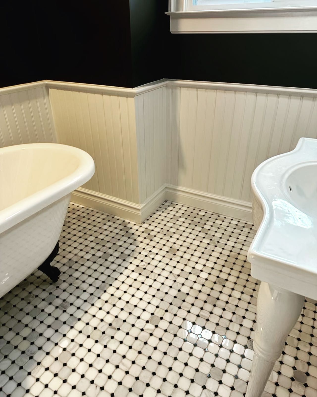 A bathroom with a claw foot tub and a sink