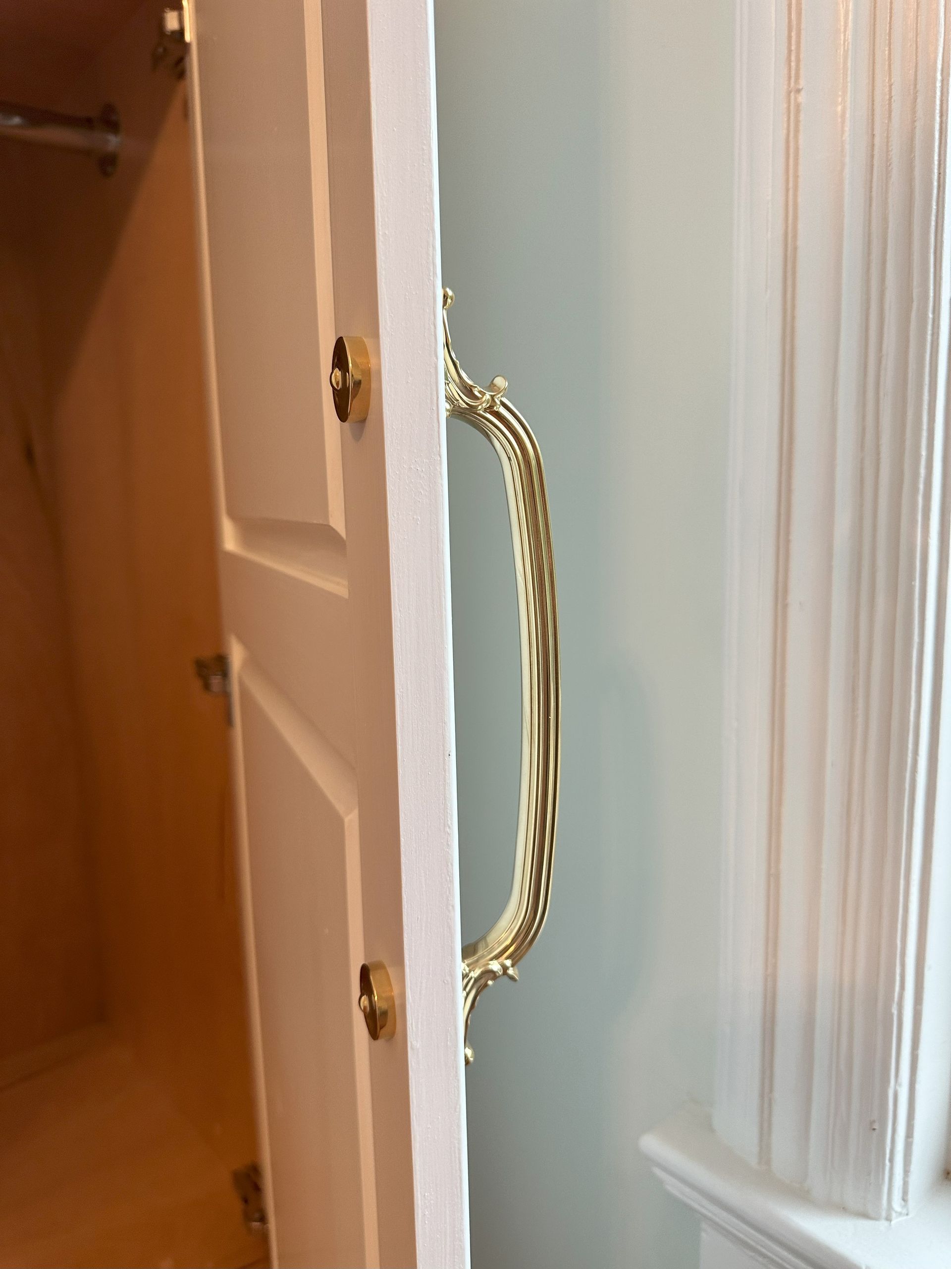 A close up of a door with a gold handle