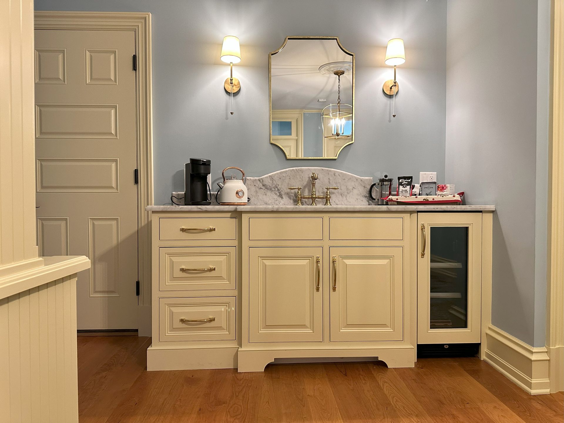 A bathroom with a sink and a mirror on the wall.