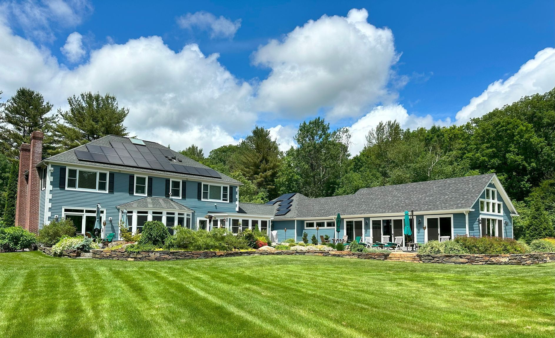 A large house with a large lawn in front of it.