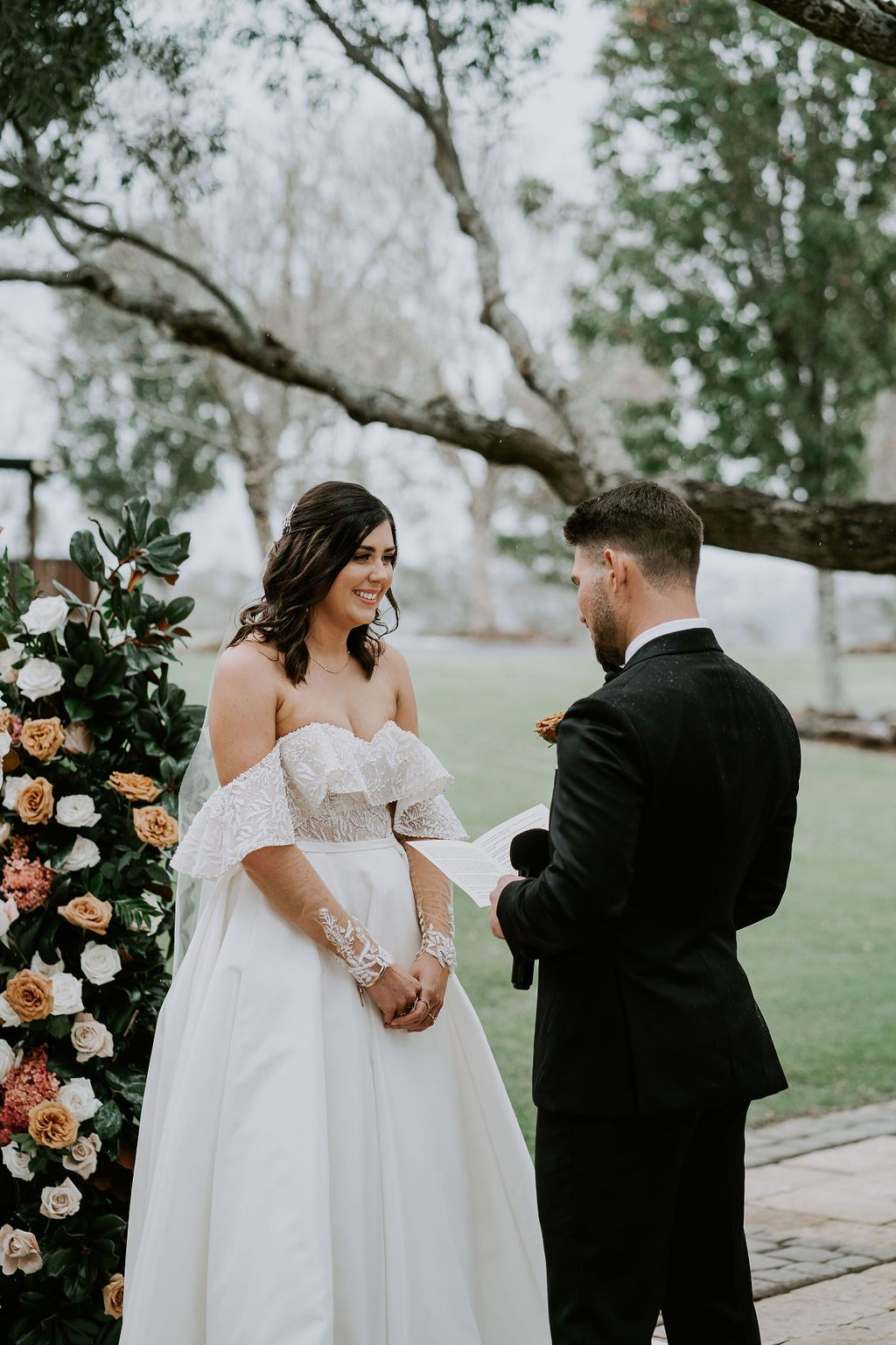 A bride and groom are standing next to each other at their wedding ceremony.