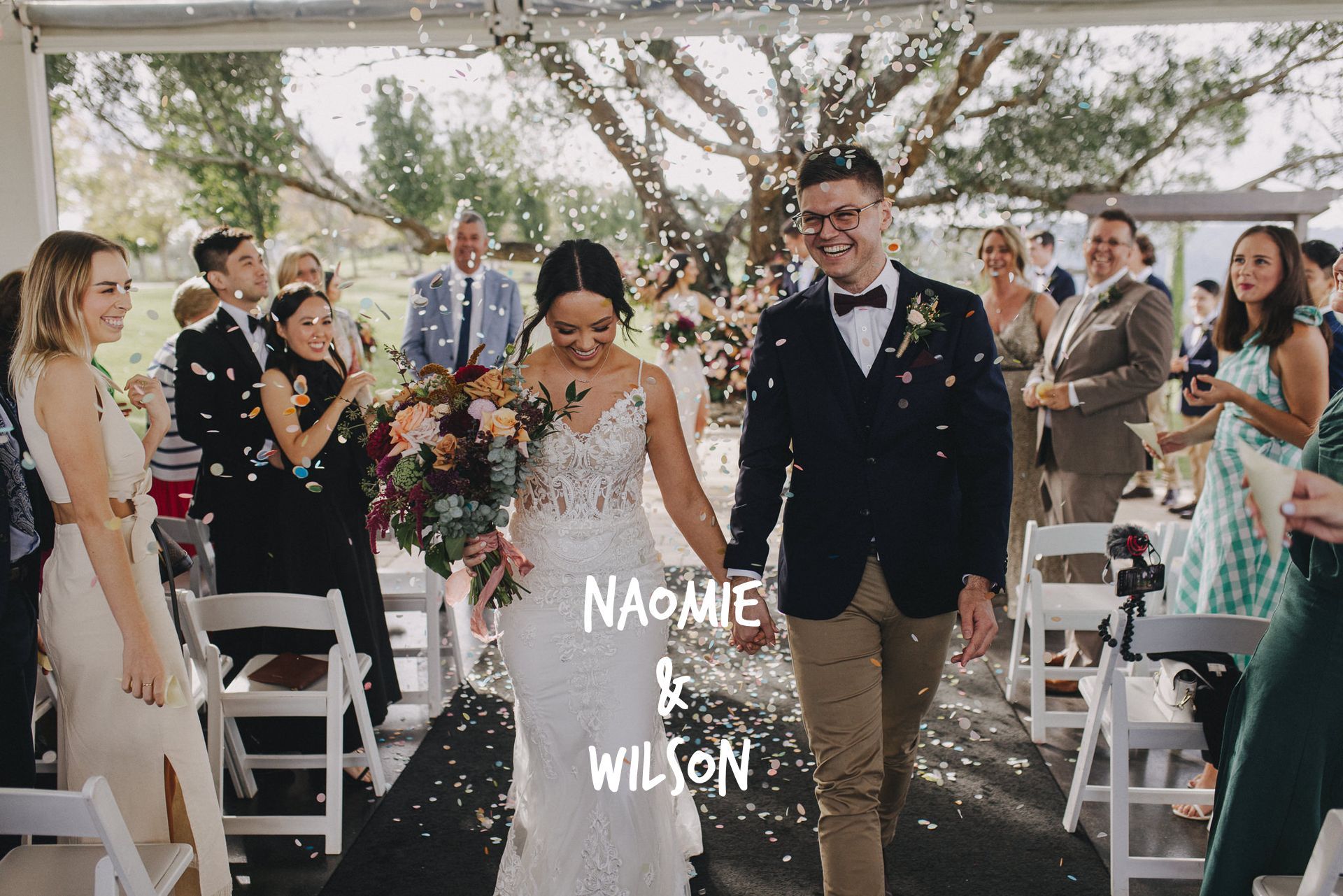 A bride and groom are walking down the aisle at their wedding.