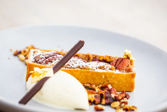 A close up of a dessert on a plate with ice cream