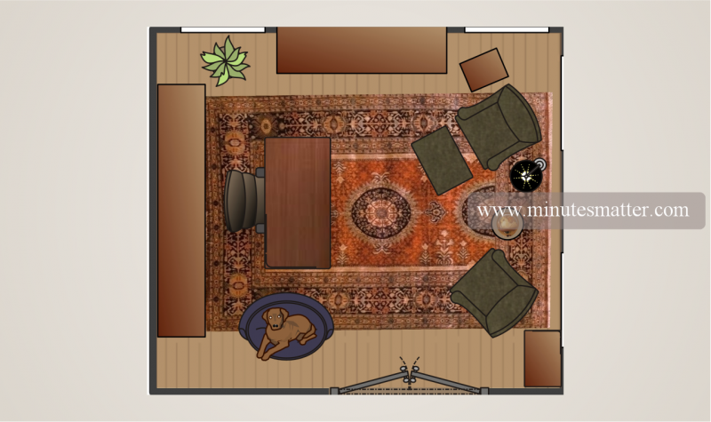 An aerial view of a living room with a rug and chairs