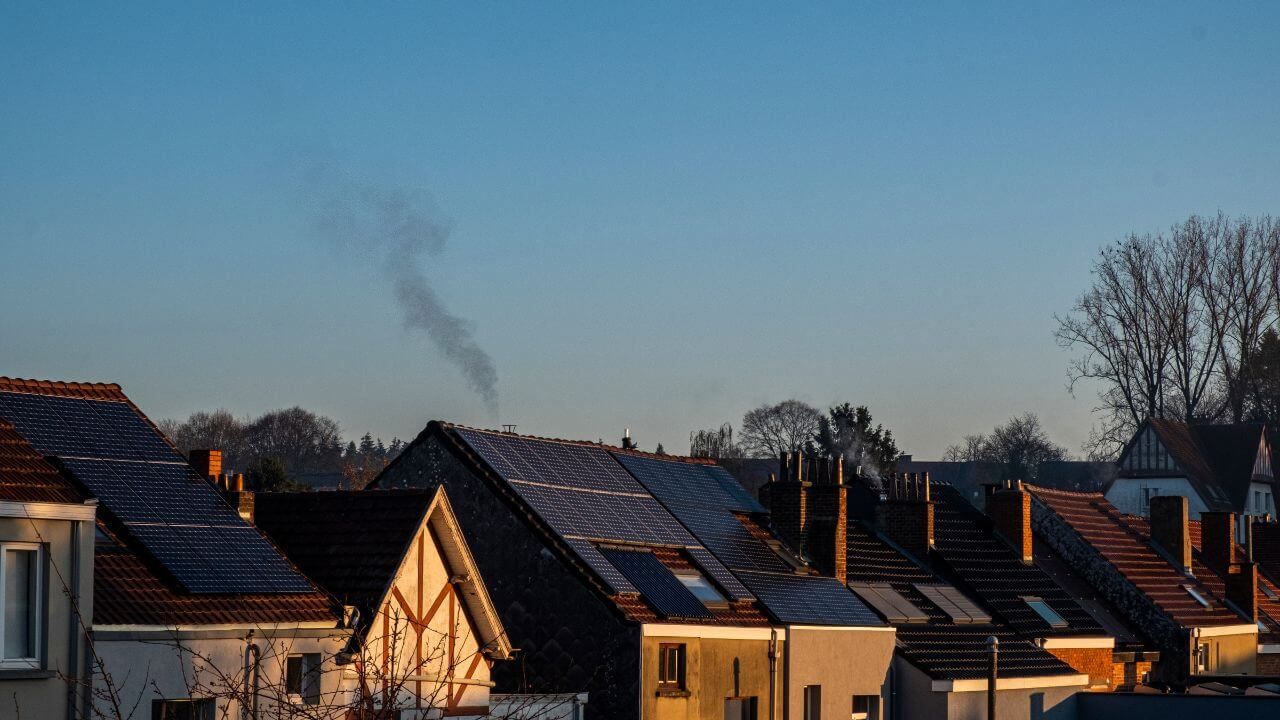 Urban houses with solar panels on roofs.