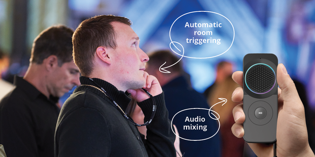 A man listening to an audio guide with the podcatcher pro next to him in the foreground
