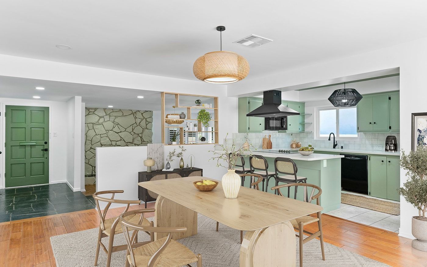 Spacious kitchen and dining area with sage green cabinets and wood accents.