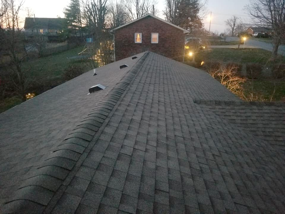 The roof of a house with a gray shingle roof.