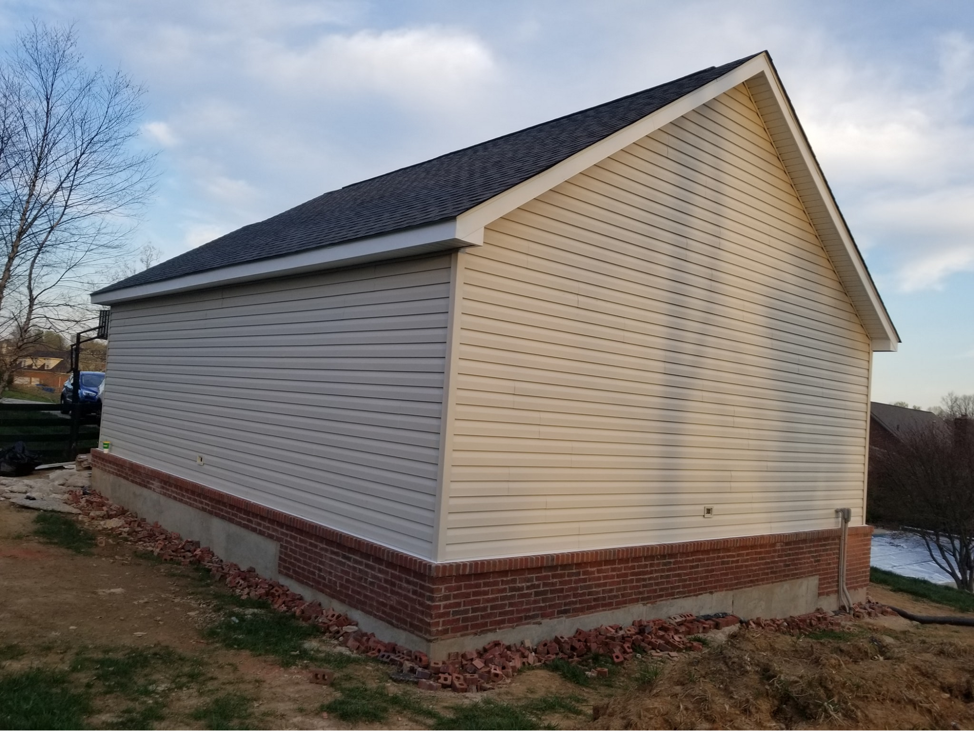 a house with white siding and a black roof