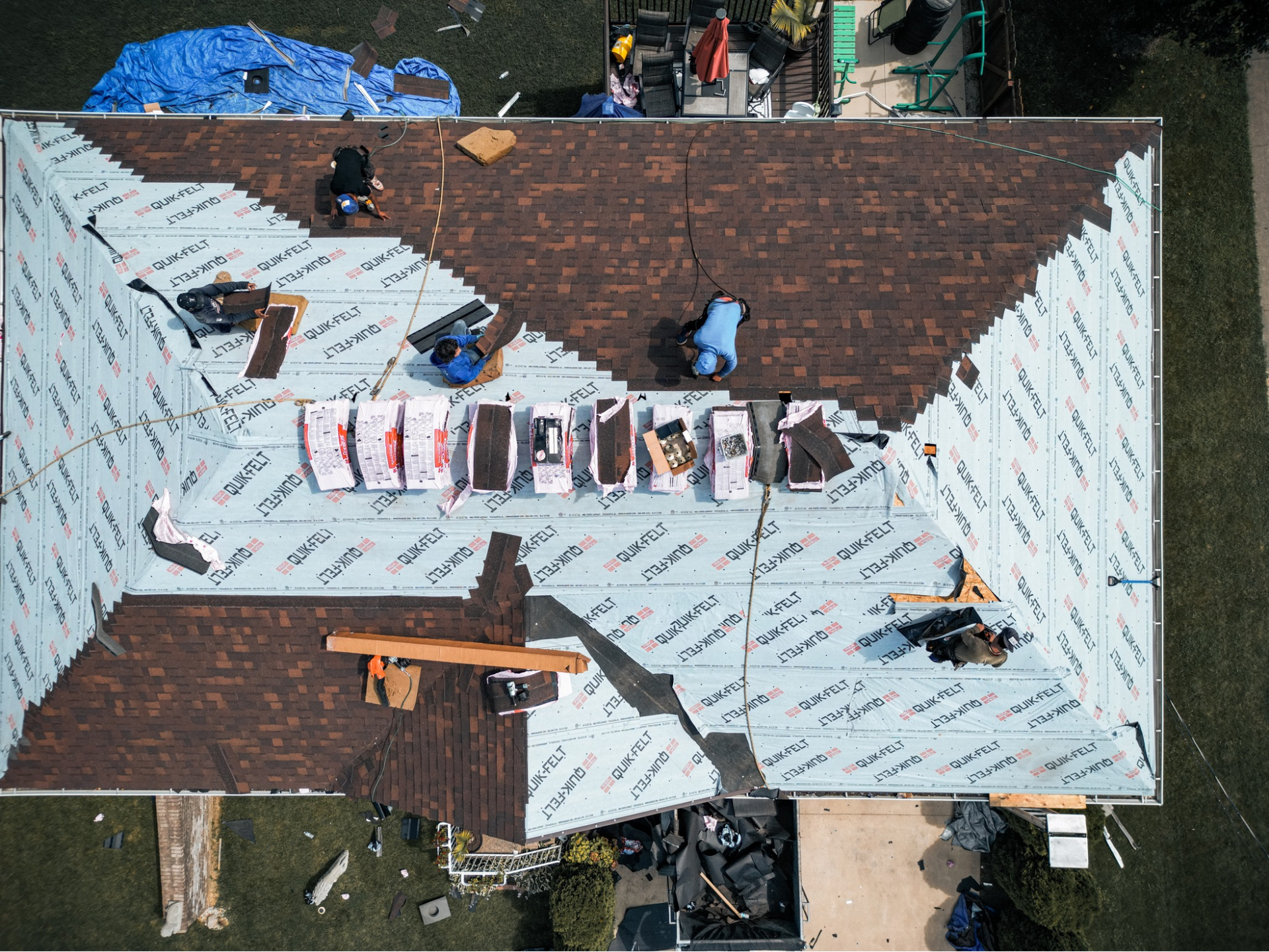 An aerial view of a roof being installed on a house.