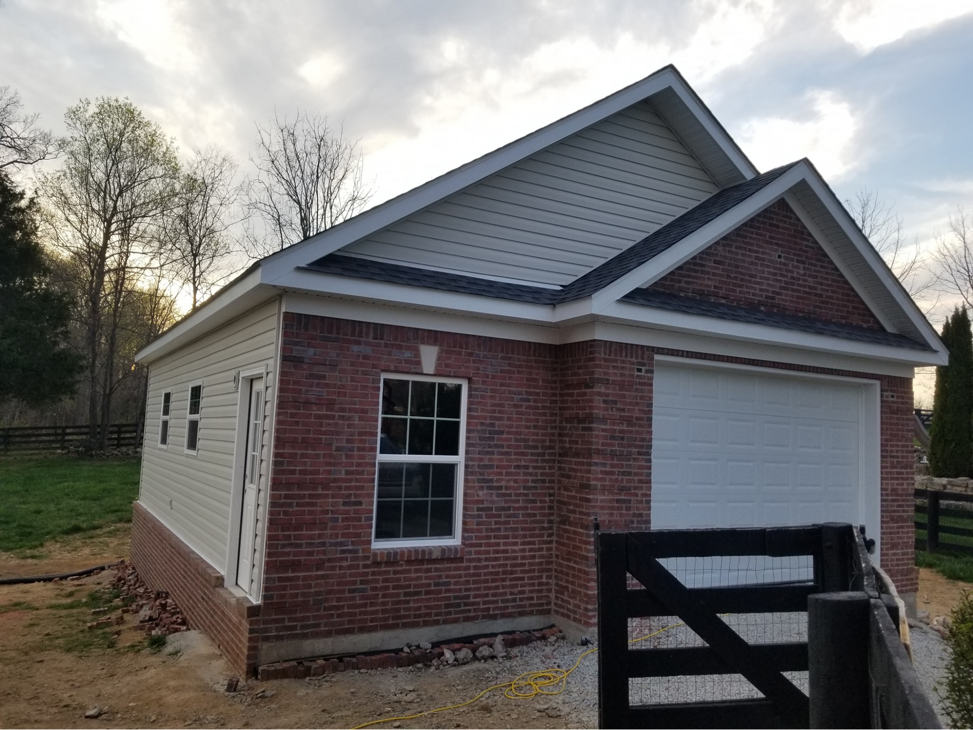 A small brick house with a white garage door