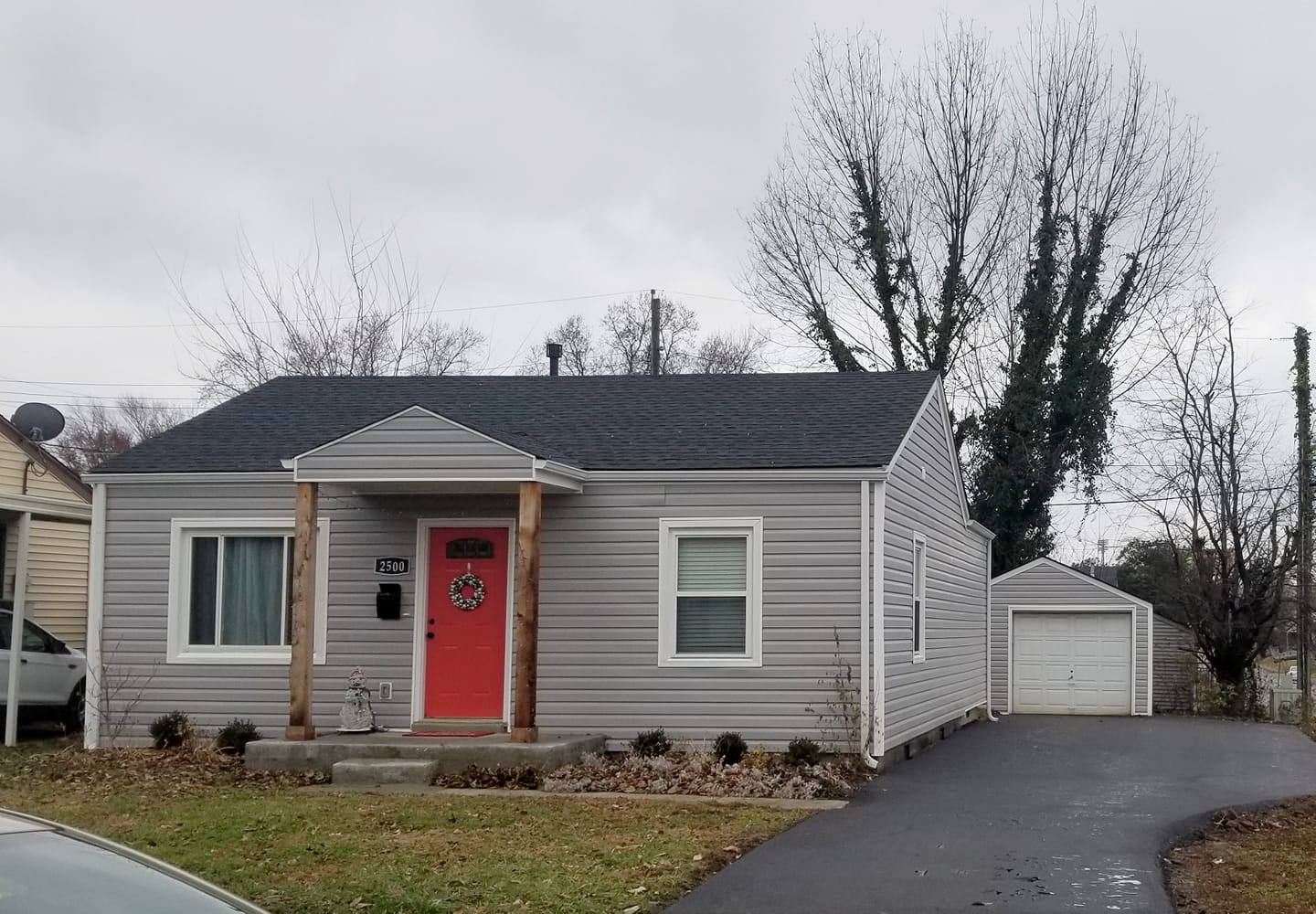 a gray house with a red door has the address 2801