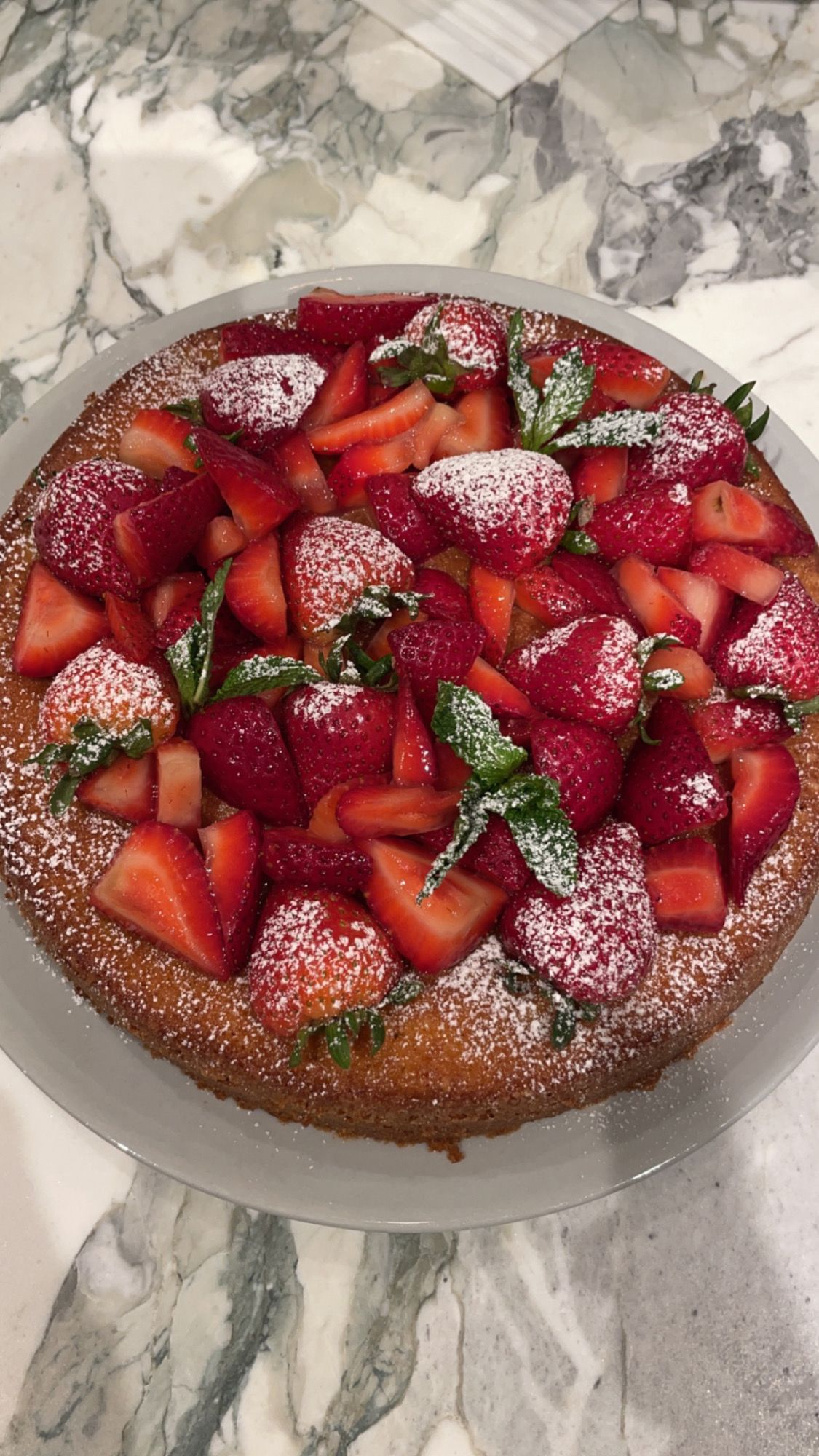 Vanilla Bean Tea Cake topped with Fresh Strawberries & Powdered Sugar