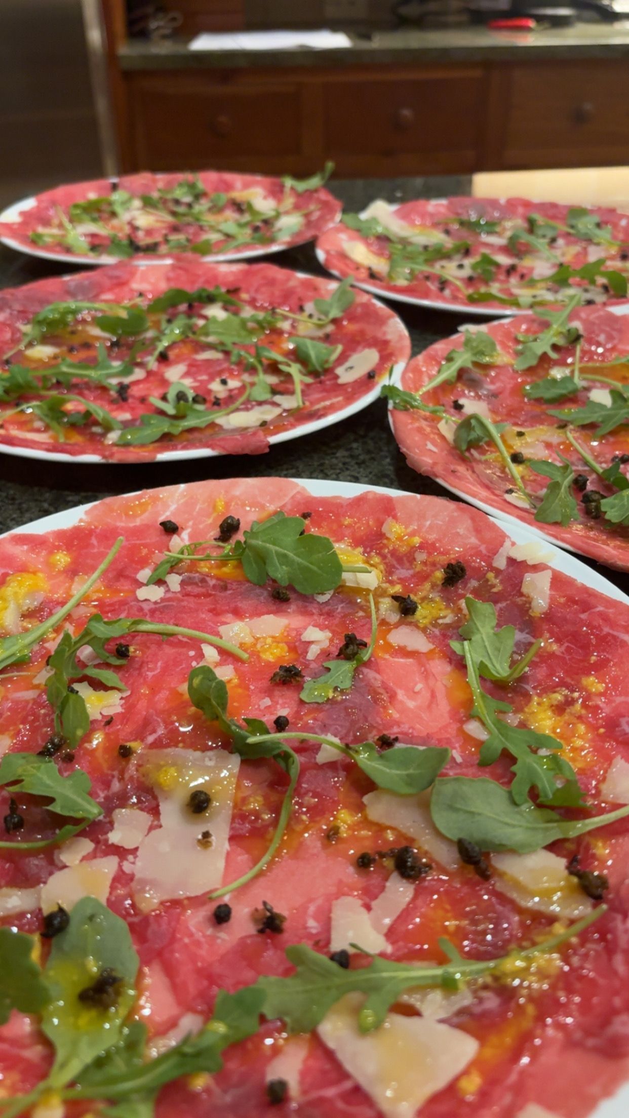 Dry Aged Filet Mignon Carpaccio topped with Arugula, Grana Padano, Truffle and Capers