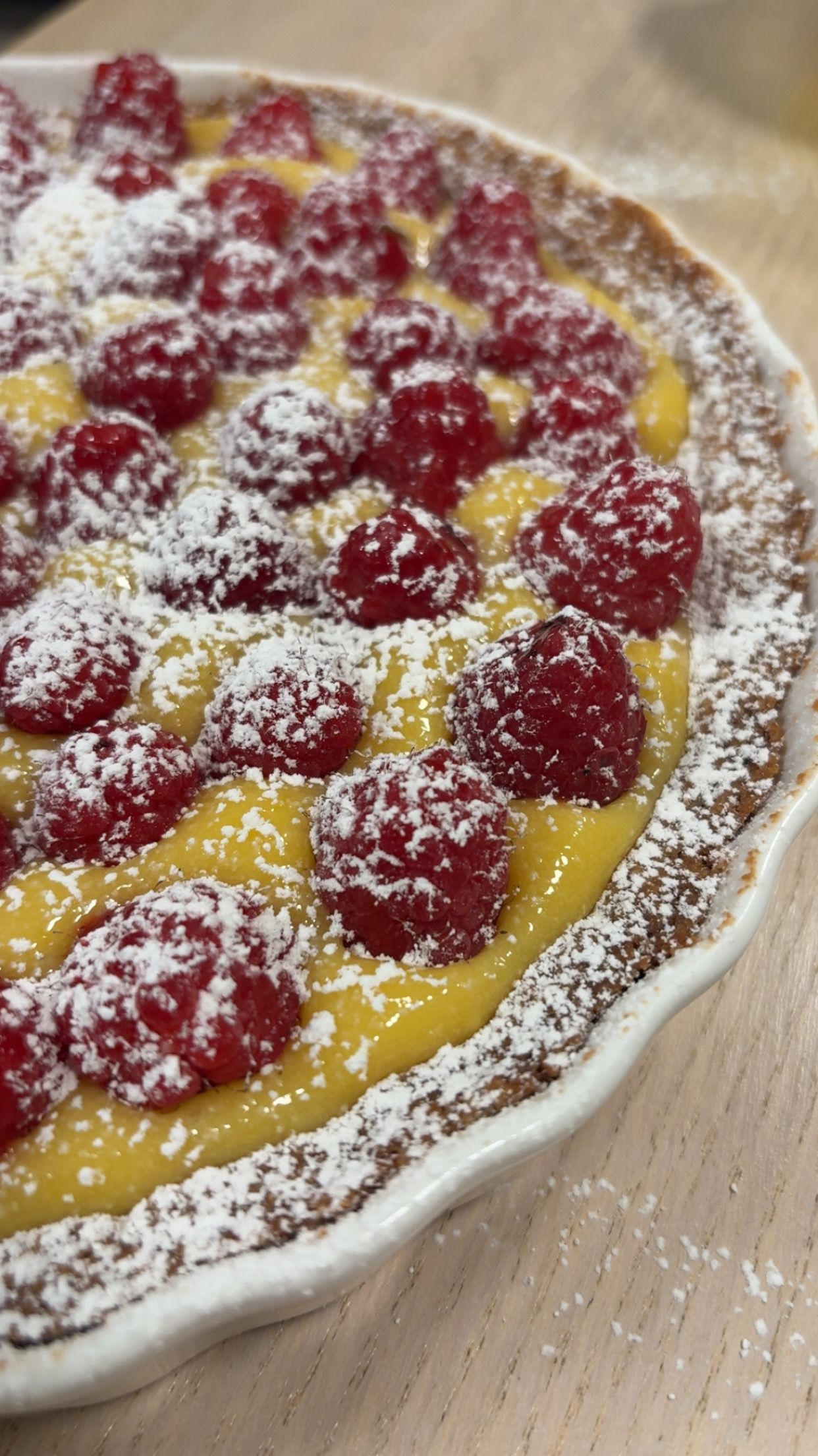 Raspberry Lemon Curd Tart topped with Powdered Sugar