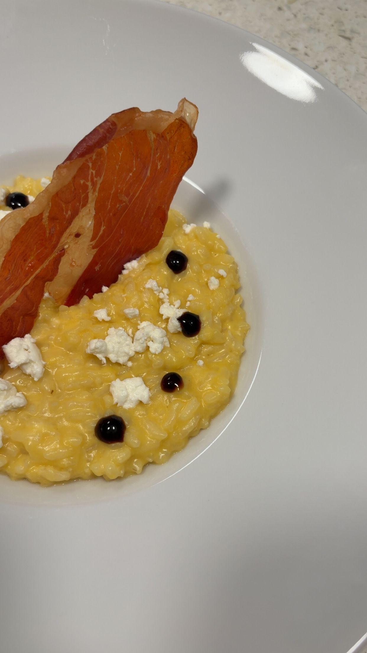 Pumpkin Risotto topped with Goat Cheese, Aged Balsamic and Crispy Prosciutto