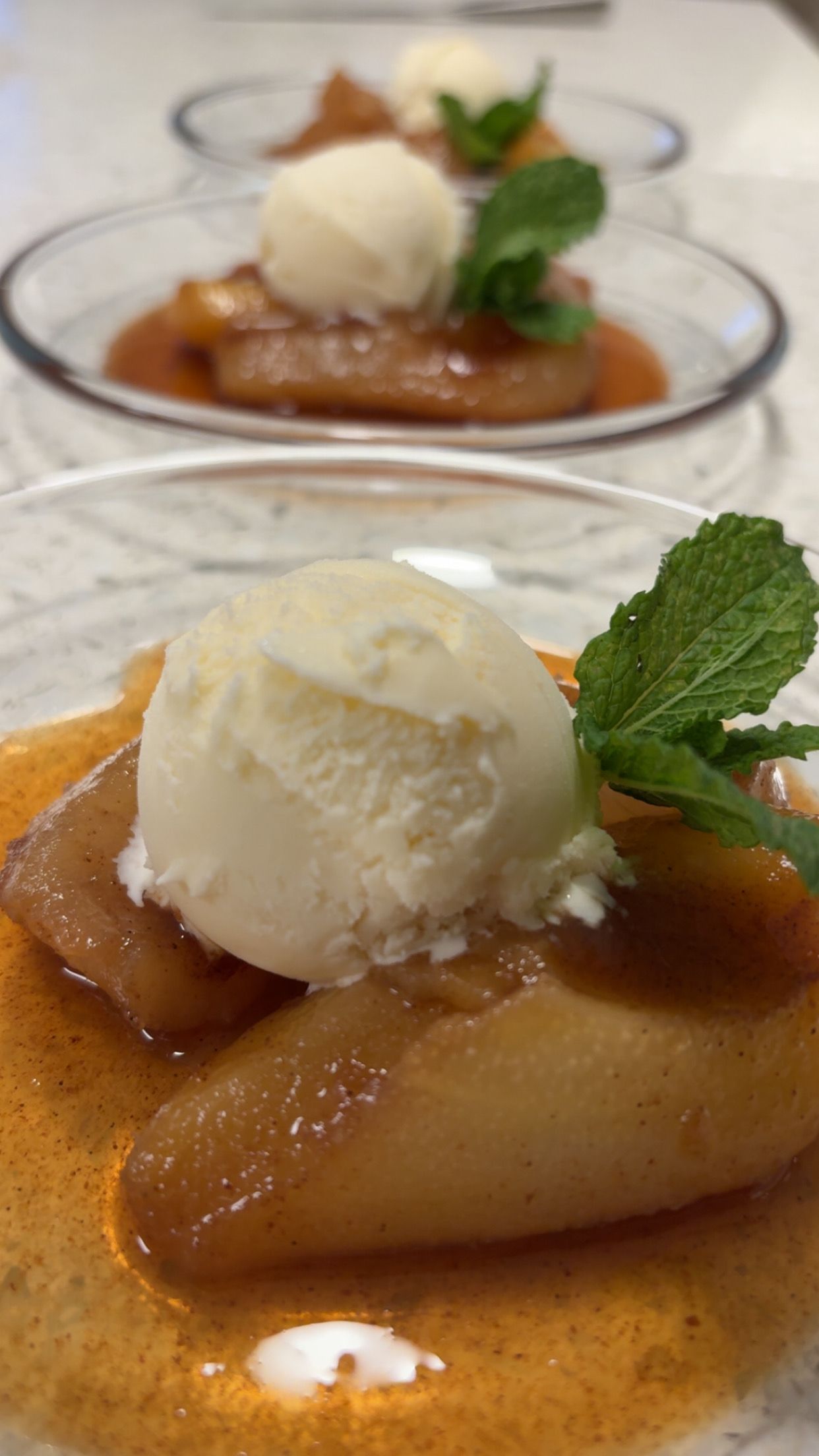 Poached Pears with vanilla ginger syrup served with house mad Earl Grey ice cream