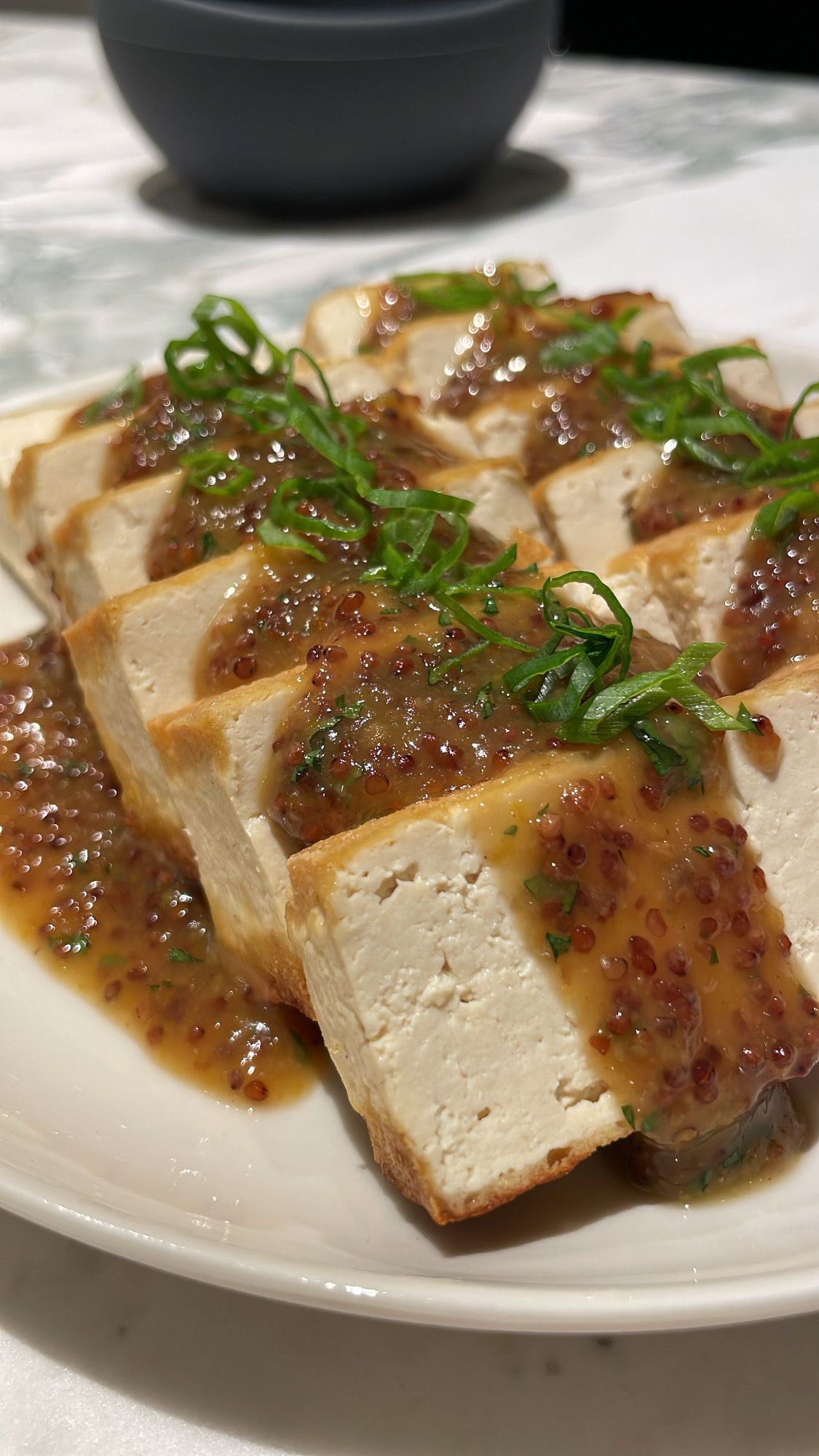 Pan Seared Tofu topped with a Miso Maple Mustard sauce and Green Onion