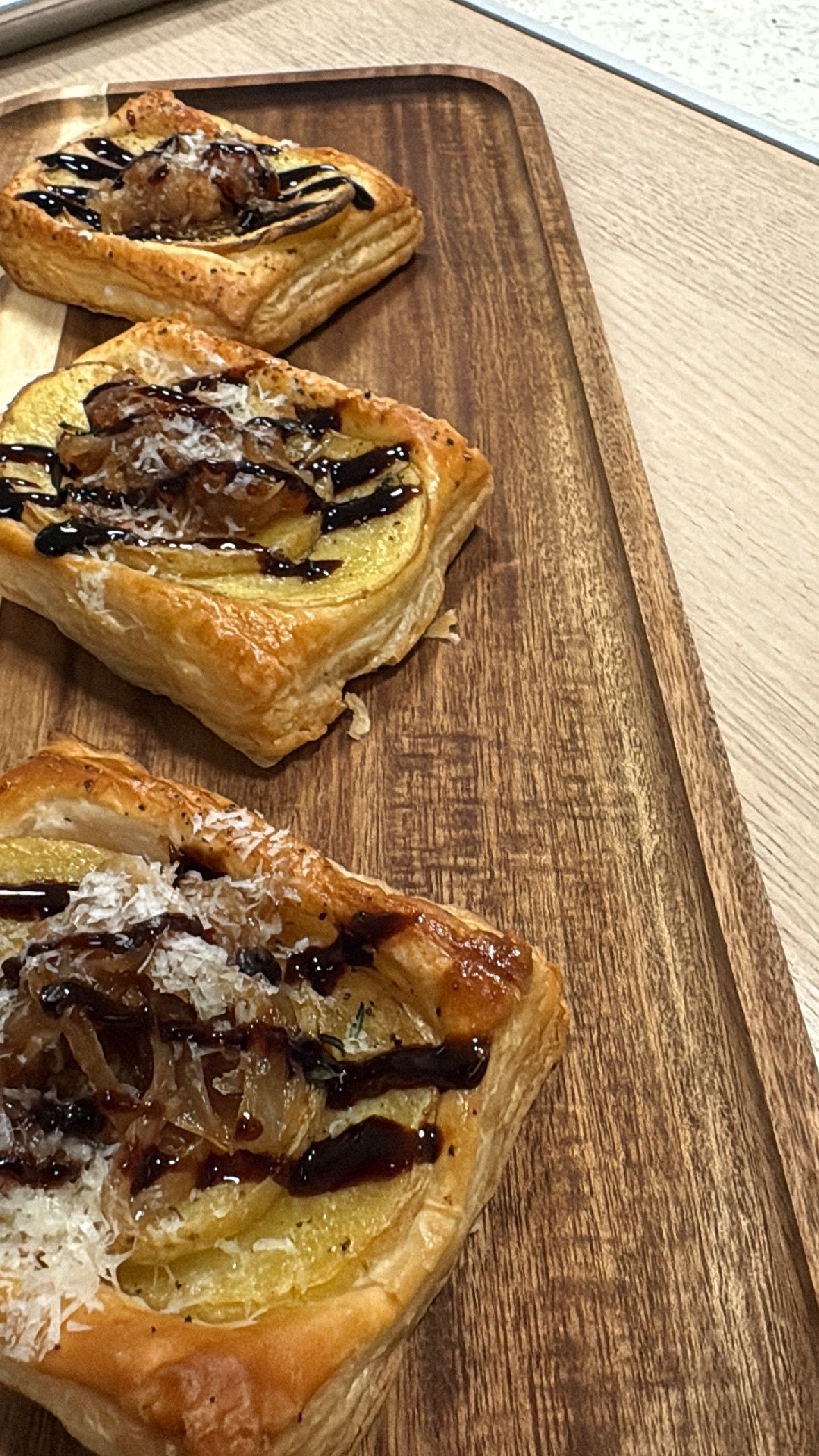 Caramelized Onion and Baby Potato Tartlets drizzled with Balsamic Glaze and Parmesan Cheese
