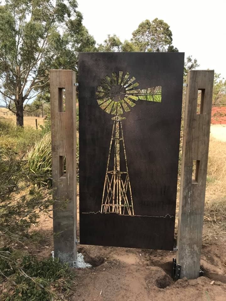 A sign with a picture of a windmill on it