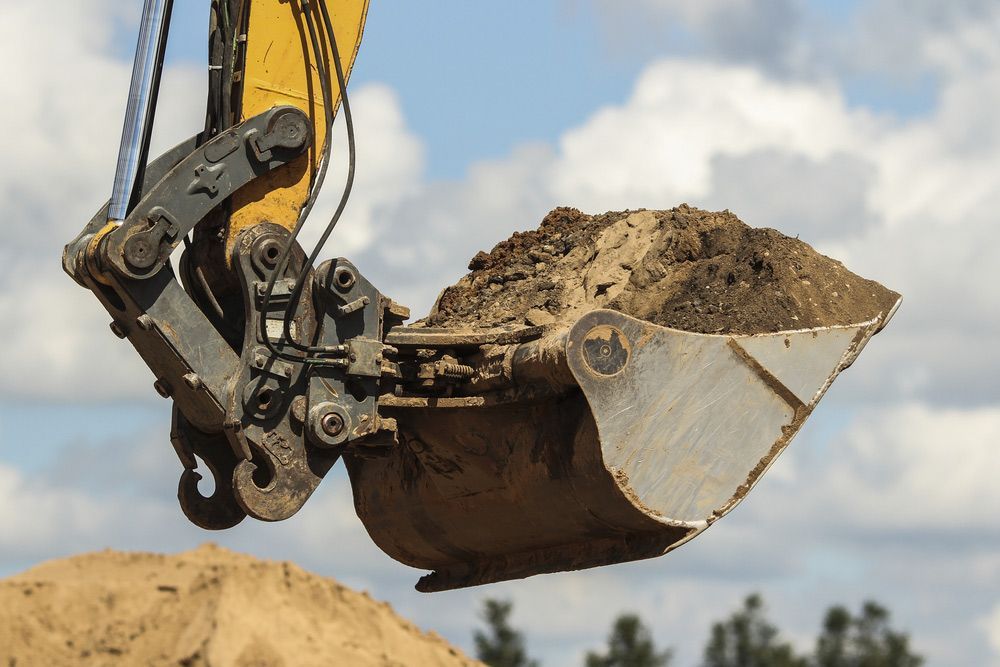 Excavator Carrying Soil — Earthworks in Corowa, NSW