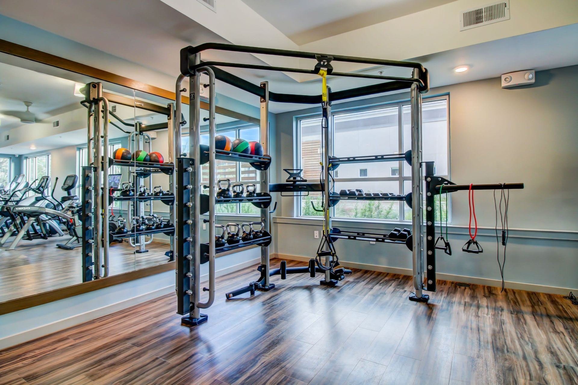 a gym with a lot of exercise equipment and a large mirror at Westerly 360 in Austin, TX.