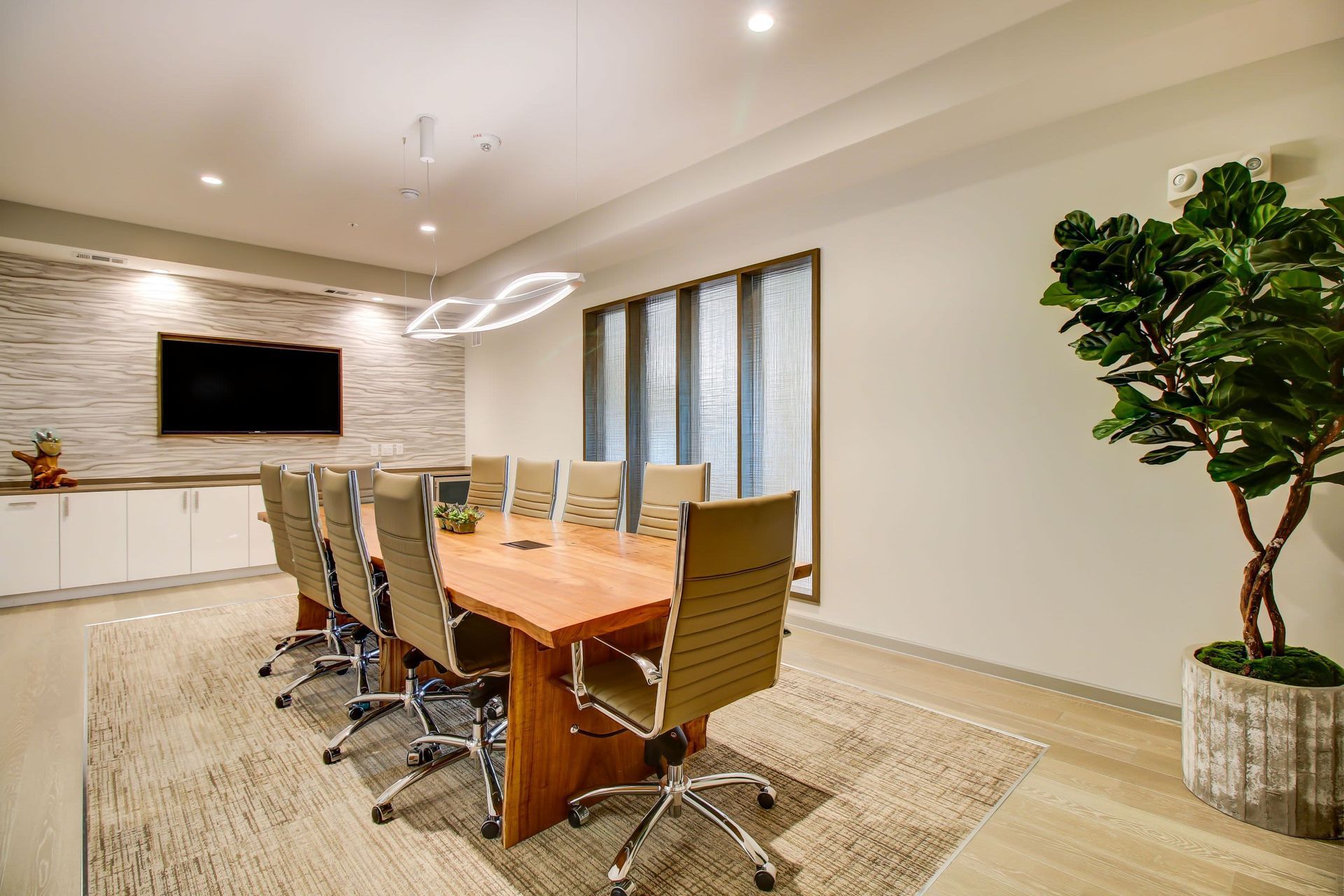 a conference room with a long wooden table and chairs at Westerly 360 in Austin, TX.