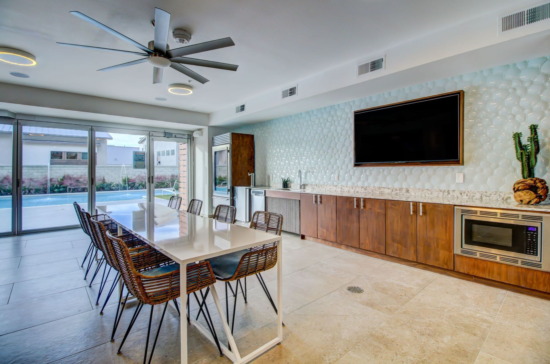 a large dining room with a table and chairs and a flat screen tv at Westerly 360 in Austin, TX.