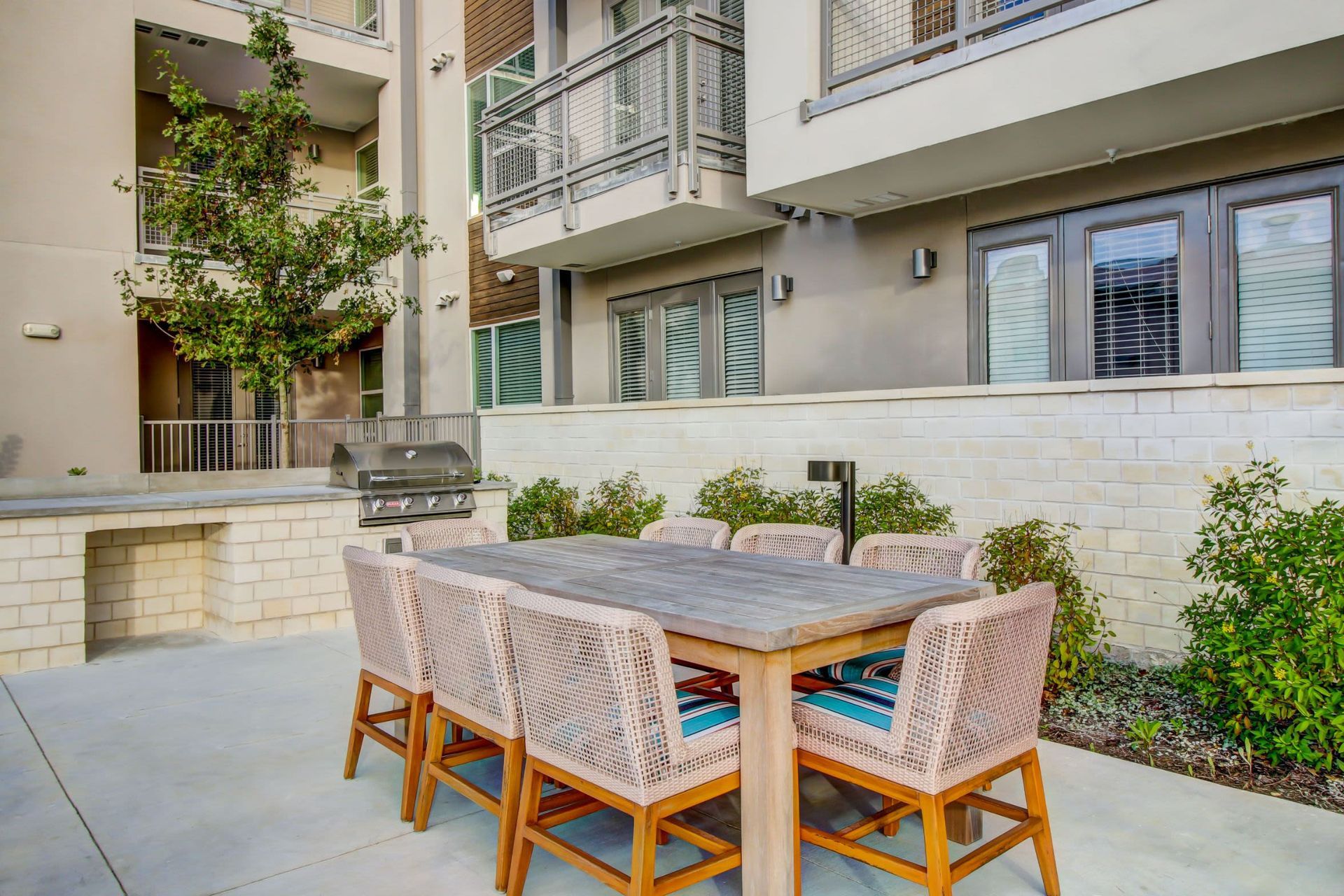 a patio with a table and chairs in front of a building at Westerly 360 in Austin, TX.