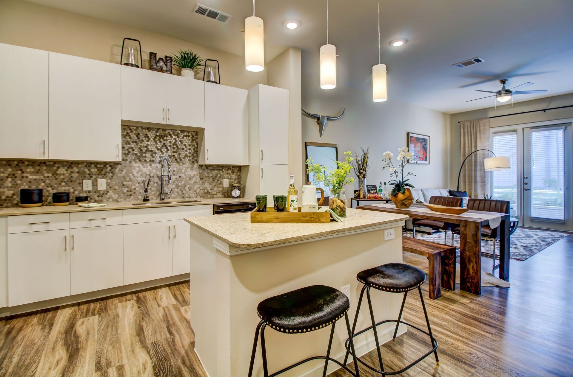 a kitchen with a large island and stools in a house at Westerly 360 in Austin, TX.