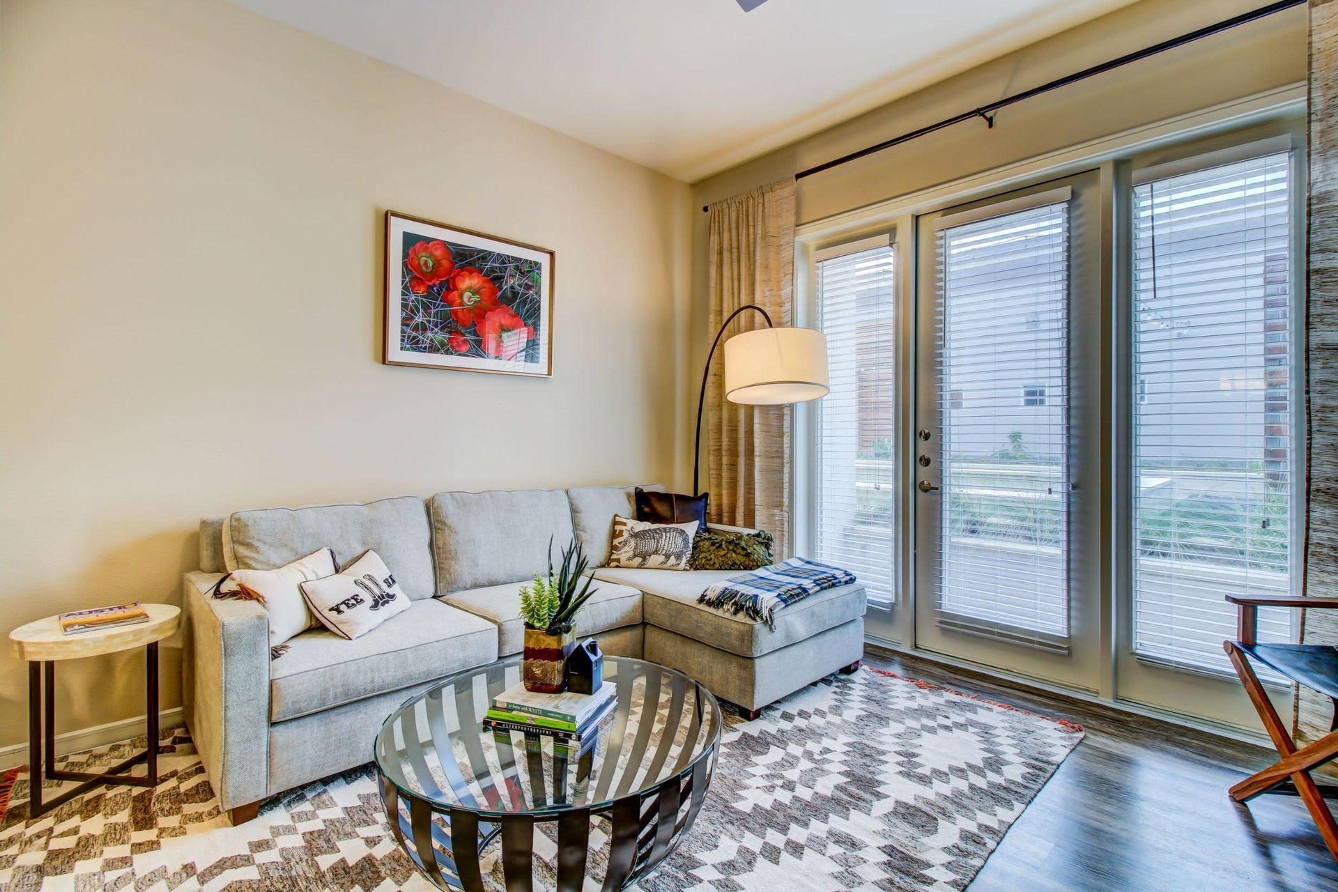 a living room with a couch , coffee table , chair and sliding glass doors at Westerly 360 in Austin, TX.