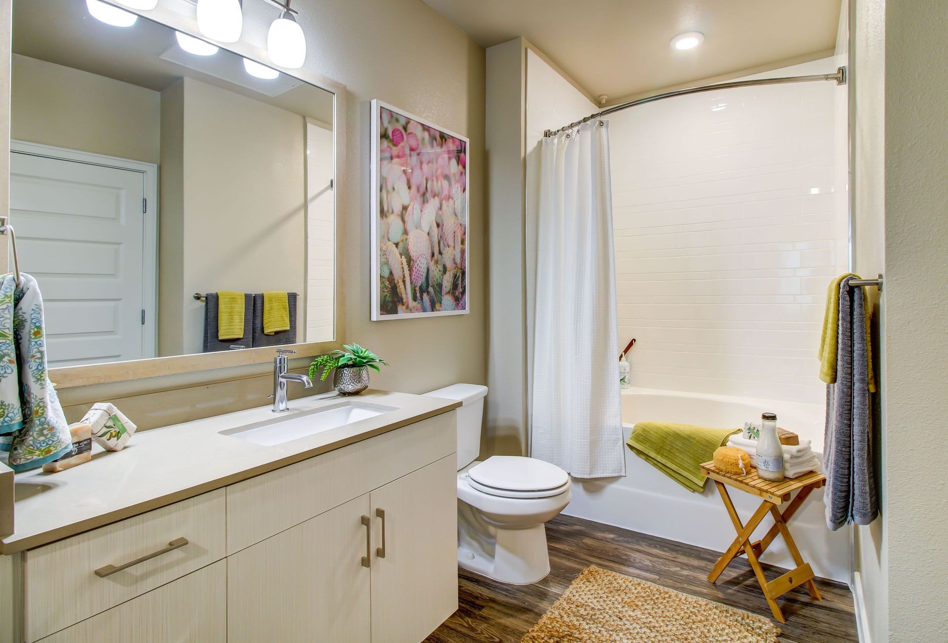 a bathroom with a sink , toilet , bathtub and mirror at Westerly 360 in Austin, TX.