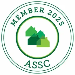 A green circle with houses in it that says member 2025 assc