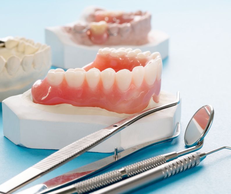 Complete Full Denture On Blue Background — Smiles on Hobart In New Town TAS