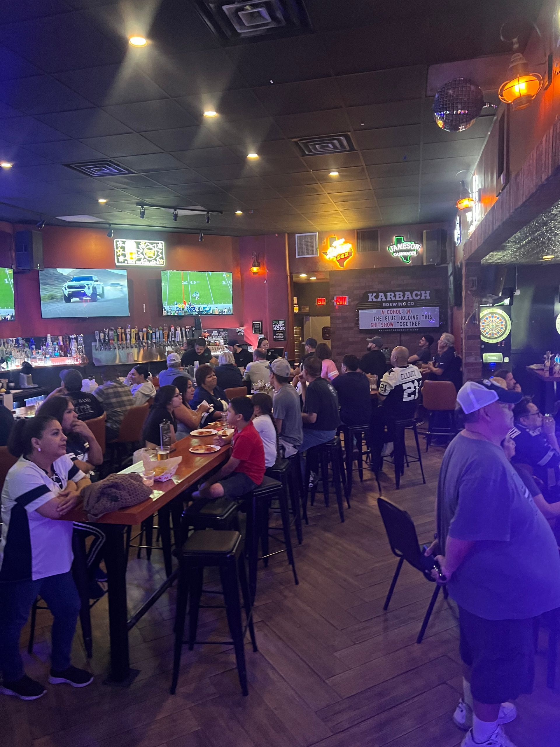 A group of people are sitting at tables in a restaurant.