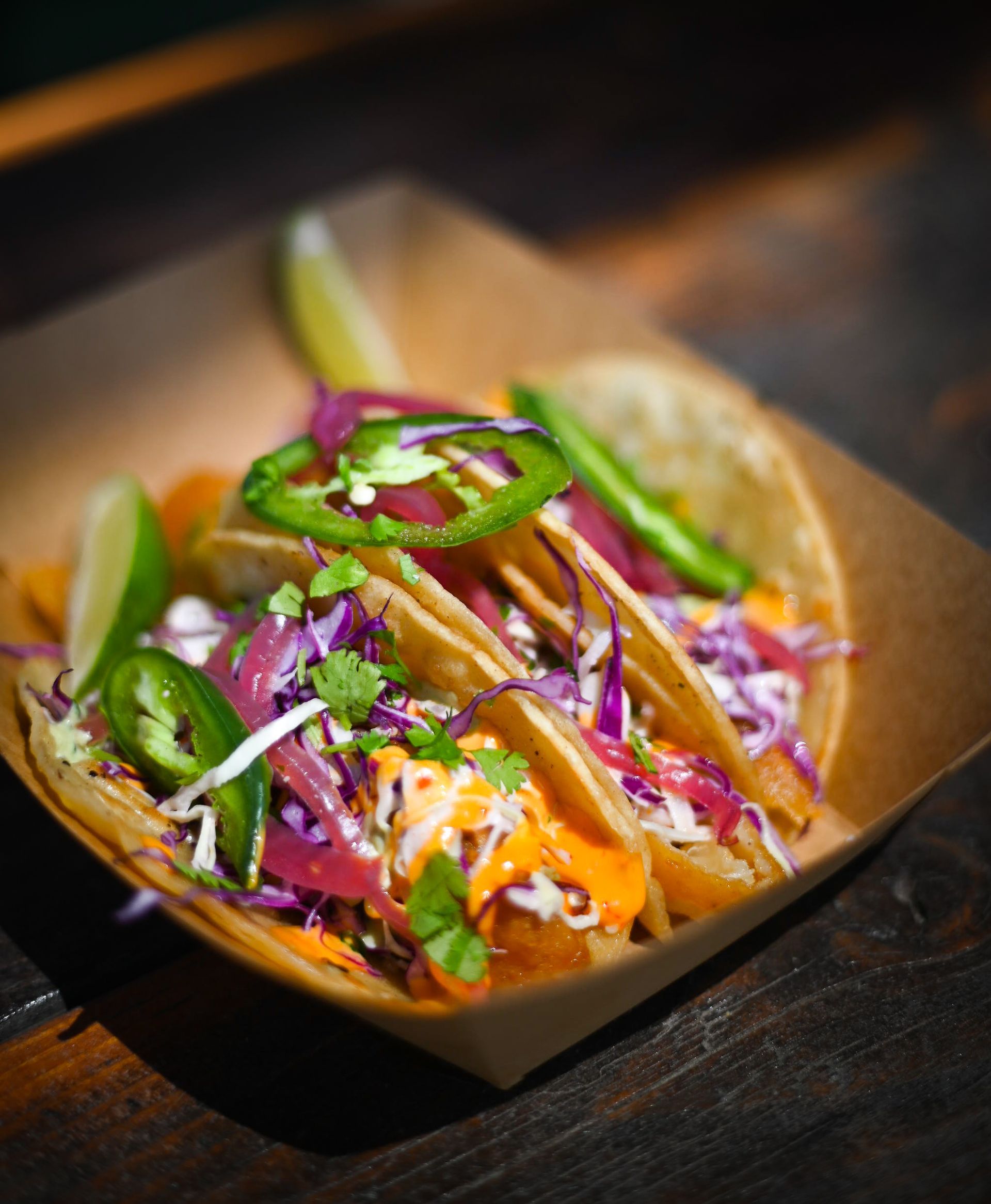 A close up of a taco in a cardboard container