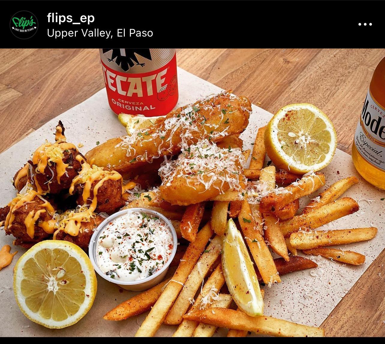 A plate of food with a bottle of tecate next to it