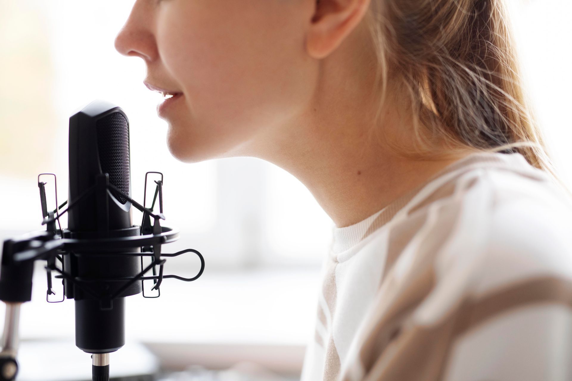 A woman is singing into a microphone.