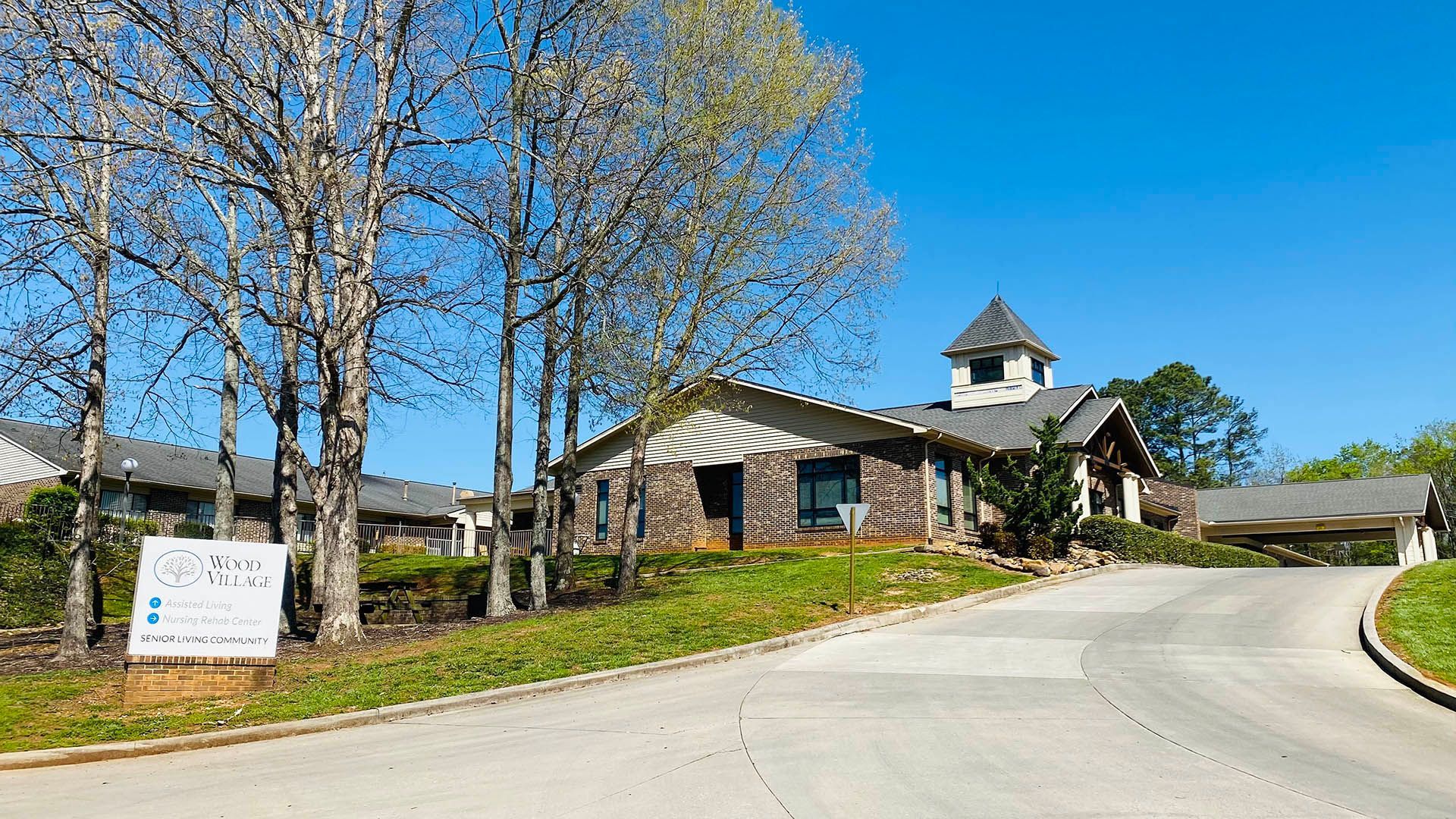 A house is sitting on top of a hill next to a road.