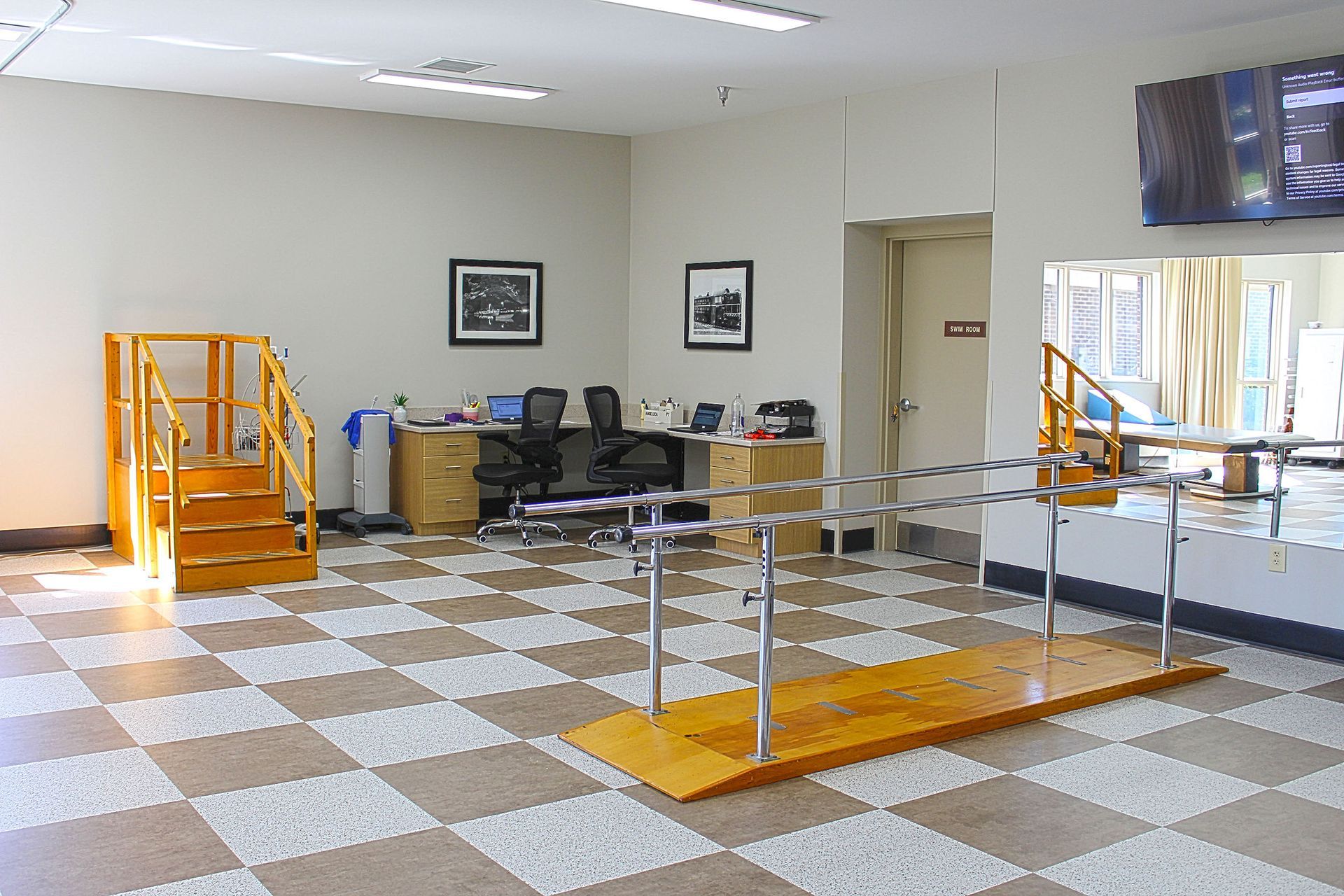 A large room with a checkered floor and stairs
