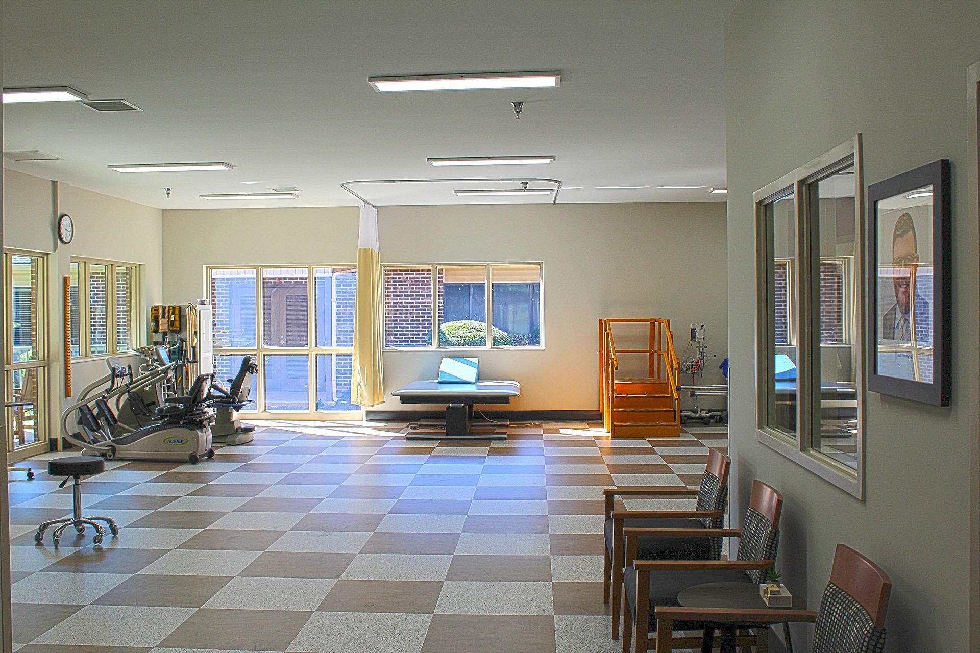 A large room with a checkered floor and chairs