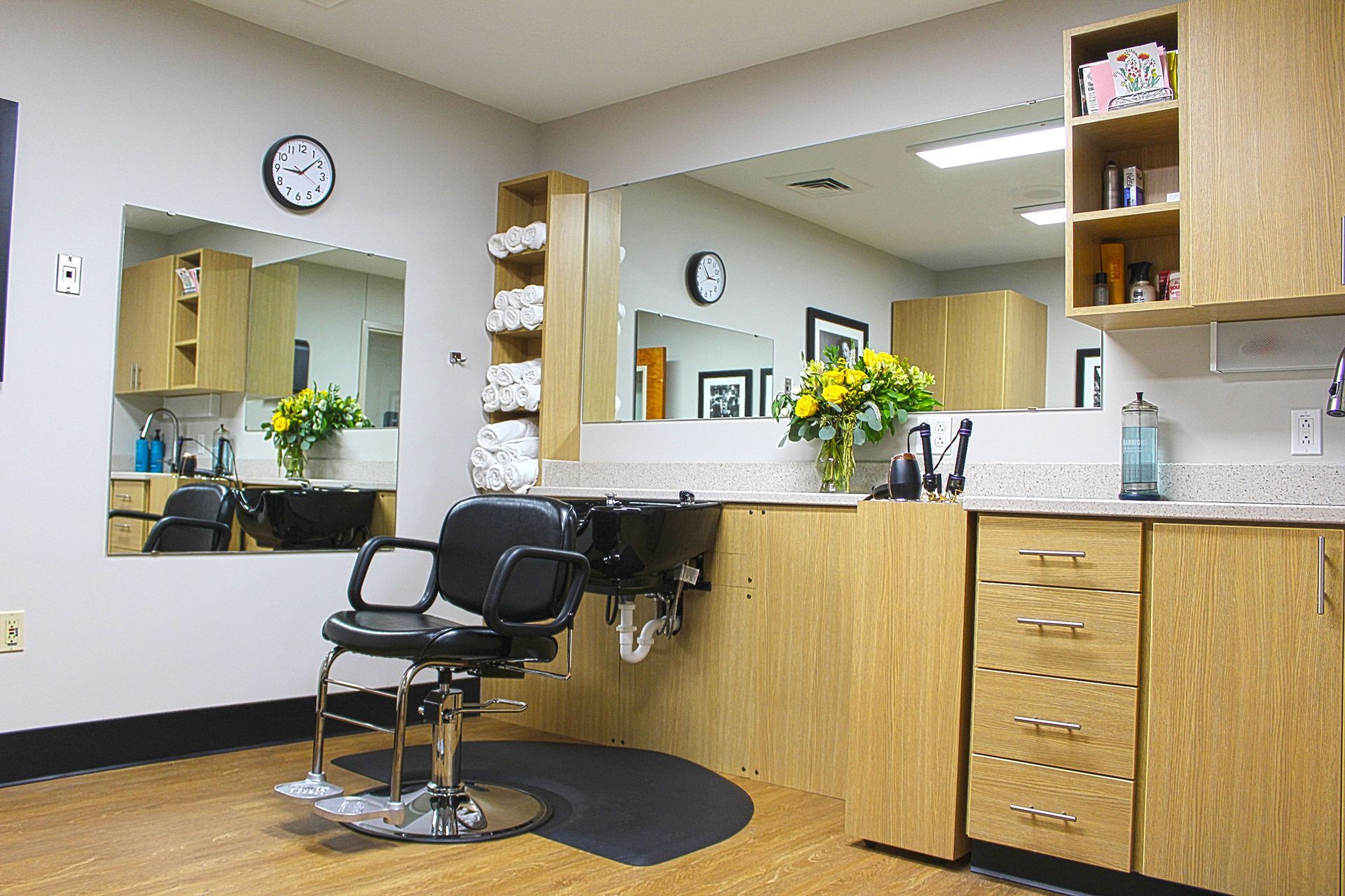 A barber shop with a chair and a sink