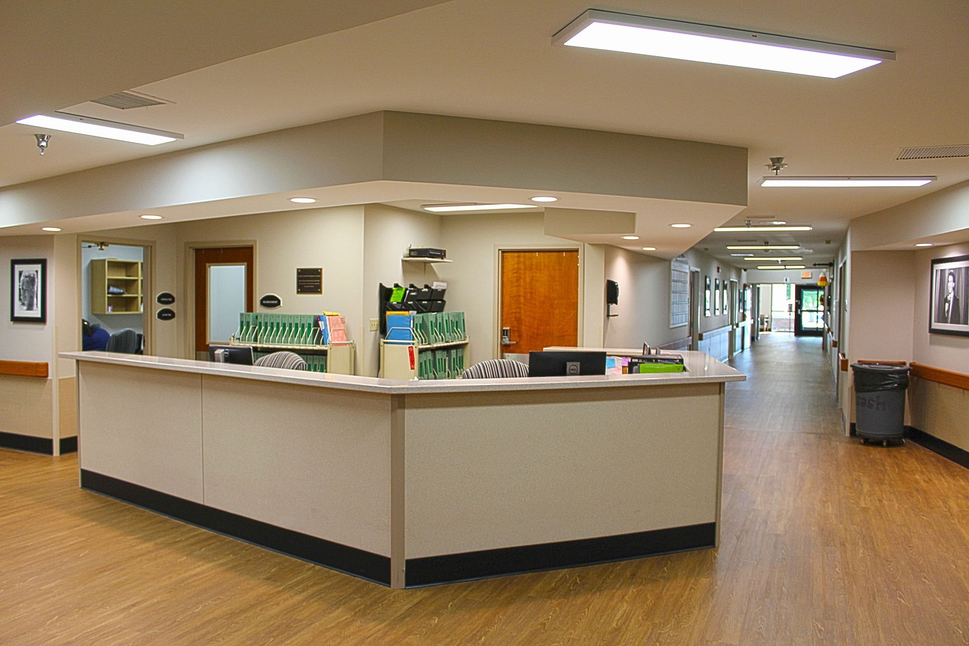 A hospital hallway with a nurse 's station in the middle