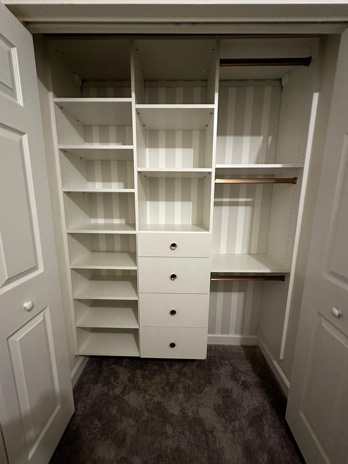 A  kids closet with lots of shelves and drawers.