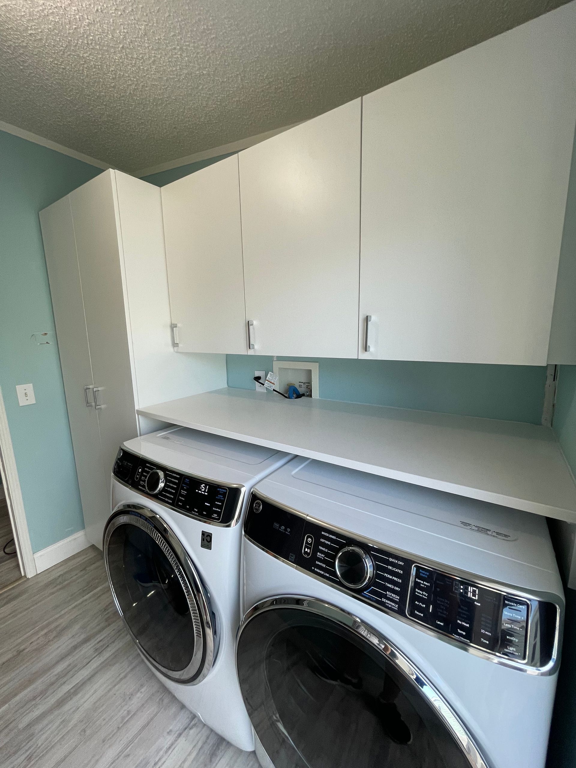 a laundry room with two washers