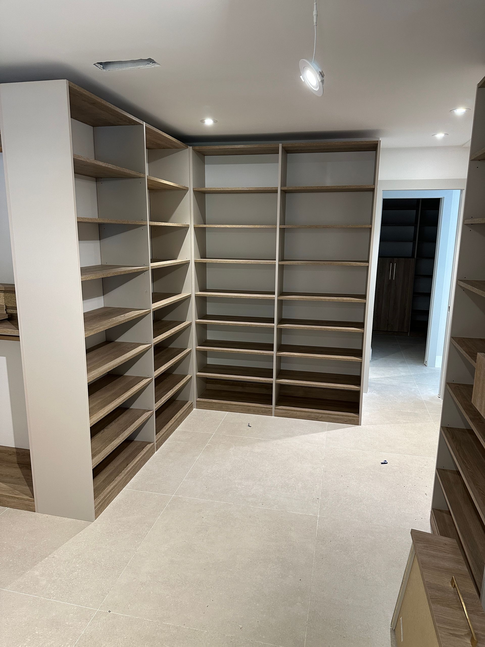 A closet with lots of shelves and drawers