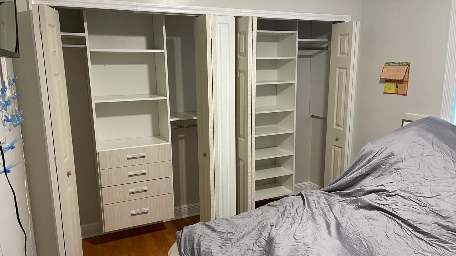 A bedroom with a bed and a walk in closet.